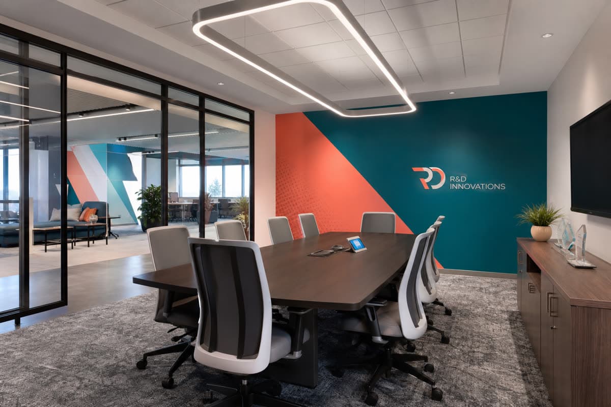 Office workspace with custom wallpaper and branded wall graphics